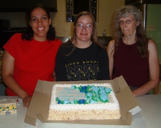Courtney, Darlene, & Cece with the Cake. Cece may have just eaten a lemon.