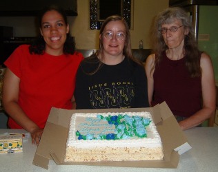 Courtney, Darlene, & Cece with the Cake. Cece may have just eaten a lemon.